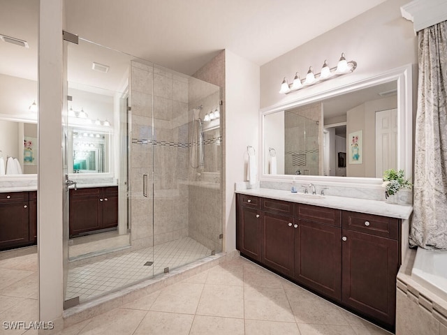 bathroom with vanity, an enclosed shower, and tile patterned floors