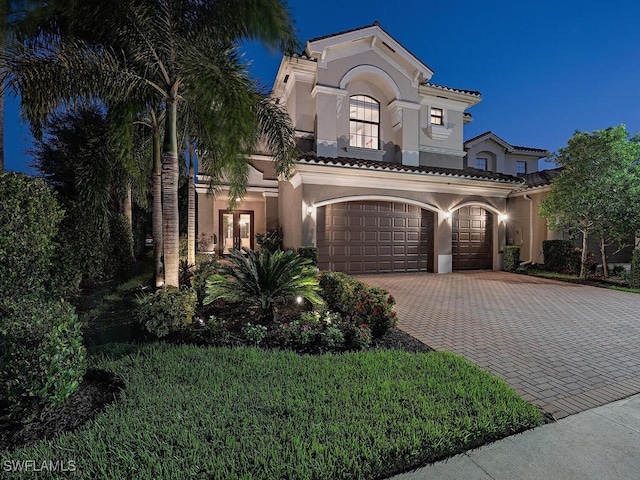 mediterranean / spanish home featuring a garage