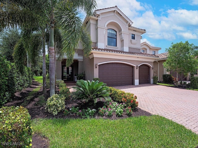 mediterranean / spanish home with a garage