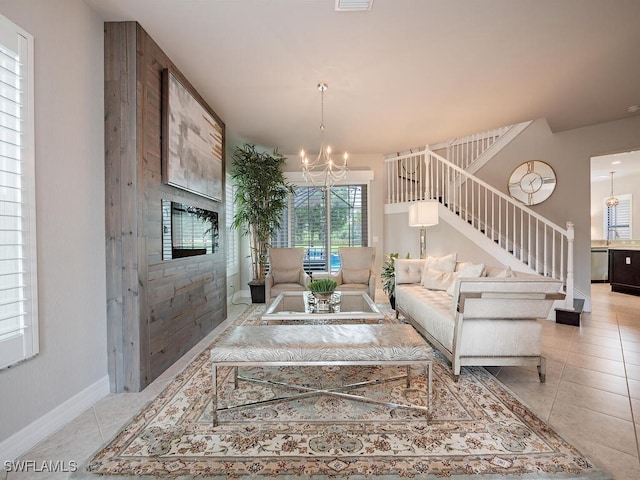 tiled living room with an inviting chandelier