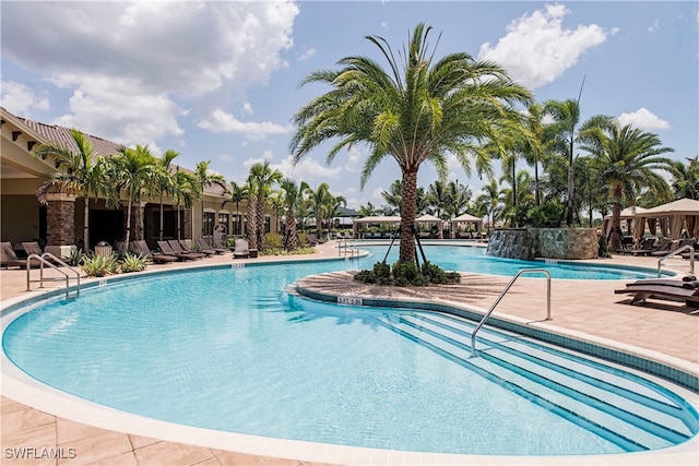 view of pool featuring pool water feature and a patio area