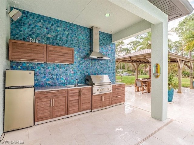 view of patio / terrace with a gazebo, sink, grilling area, and exterior kitchen