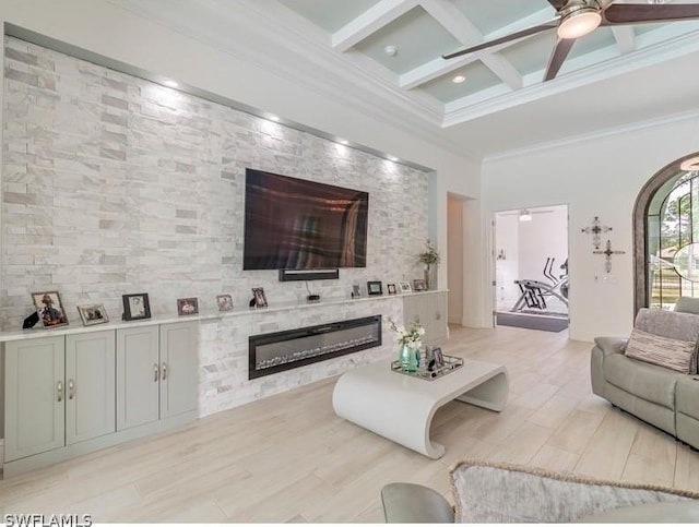 living room with ceiling fan, beamed ceiling, coffered ceiling, and ornamental molding