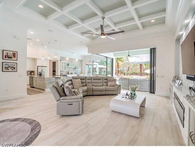 living room with beamed ceiling, light hardwood / wood-style flooring, ceiling fan, and coffered ceiling