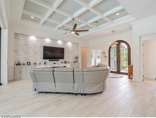 unfurnished living room featuring french doors, ornamental molding, coffered ceiling, ceiling fan, and beamed ceiling