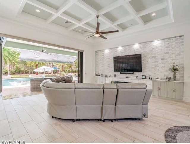 living room with ceiling fan, beam ceiling, ornamental molding, and coffered ceiling