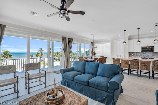 living room featuring a water view, ceiling fan, crown molding, and light hardwood / wood-style floors