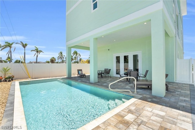 view of pool featuring a patio area and french doors