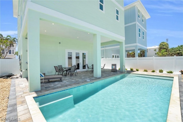 view of pool with a patio area and french doors