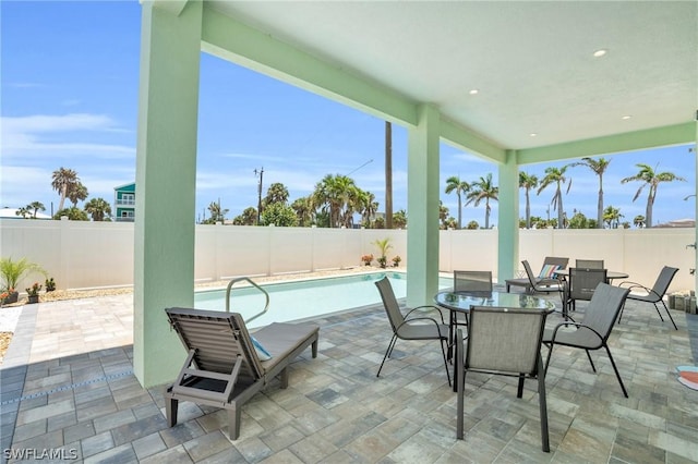 view of patio featuring a fenced in pool