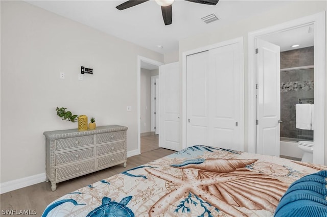 bedroom featuring ensuite bathroom, a closet, hardwood / wood-style flooring, and ceiling fan