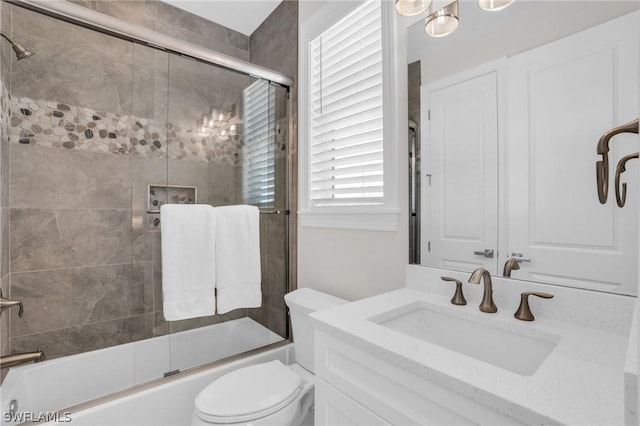 full bathroom featuring vanity, toilet, and enclosed tub / shower combo