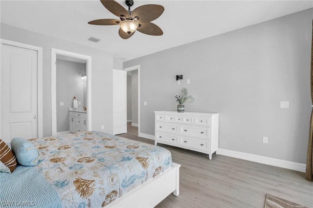 bedroom with connected bathroom, light hardwood / wood-style flooring, and ceiling fan