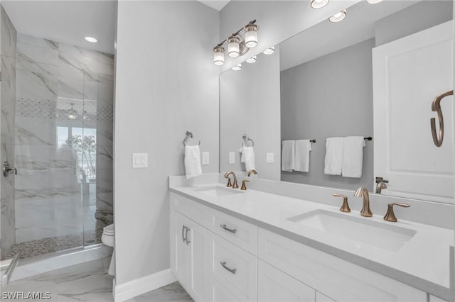 bathroom with vanity, toilet, and a shower with shower door