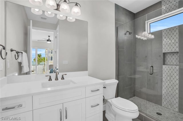 bathroom with a wealth of natural light, ceiling fan, vanity, and a shower with shower door