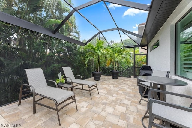 view of patio featuring a lanai