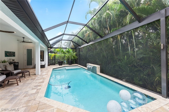 view of pool with pool water feature, a patio, a lanai, and ceiling fan