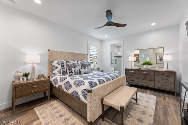 bedroom with connected bathroom, ceiling fan, and hardwood / wood-style floors