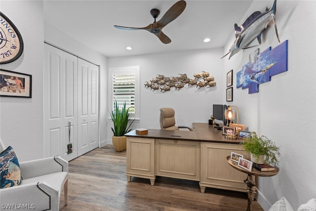 home office with ceiling fan and hardwood / wood-style floors