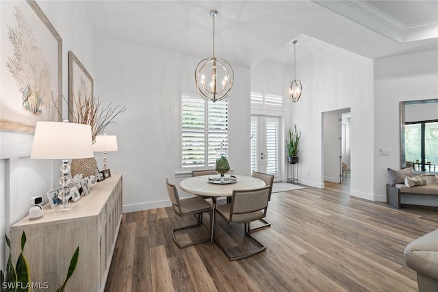 dining room featuring a chandelier, dark wood-style flooring, baseboards, french doors, and ornamental molding