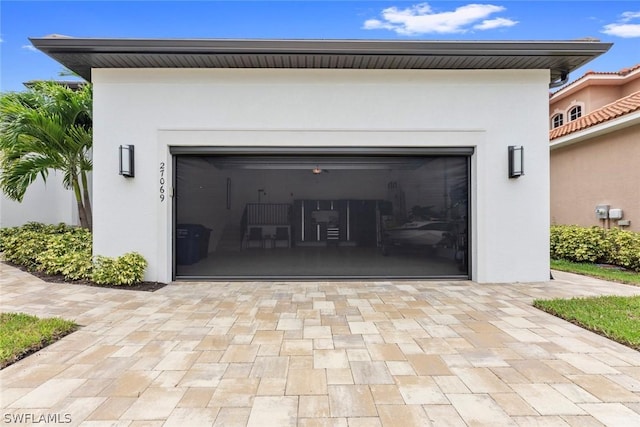 garage with decorative driveway