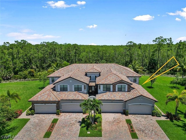 mediterranean / spanish-style house with a front yard