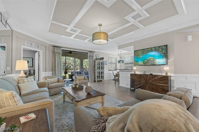 tiled living room with ornamental molding and coffered ceiling