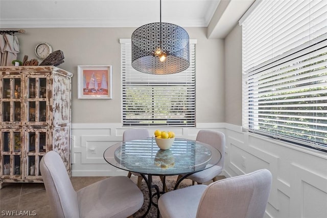 dining space featuring tile patterned flooring and ornamental molding