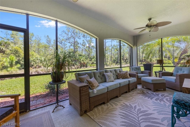 sunroom / solarium featuring ceiling fan