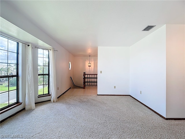 unfurnished room with light carpet