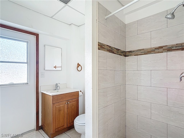 bathroom with vanity, a tile shower, and toilet