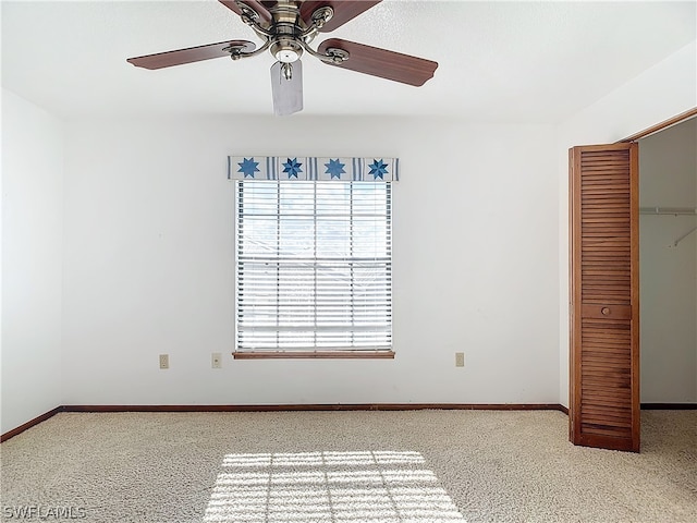 unfurnished bedroom featuring light carpet, a closet, and ceiling fan