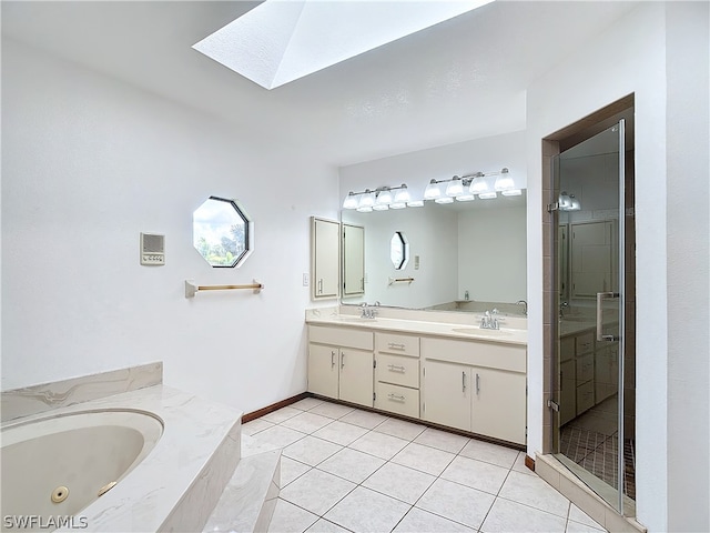 bathroom with vanity, independent shower and bath, tile patterned floors, and a skylight