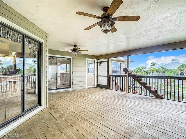 wooden deck with ceiling fan and a mountain view