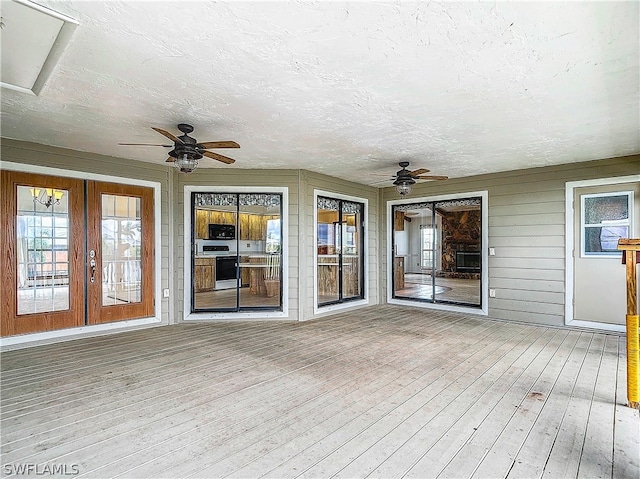 unfurnished sunroom with french doors and ceiling fan