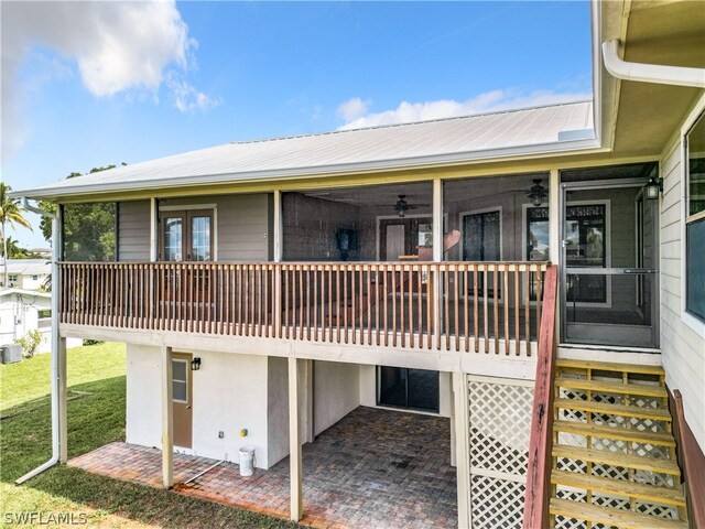 back of house featuring a patio, a lawn, and ceiling fan