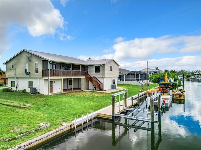 dock area featuring central air condition unit, a lanai, a lawn, and a water view