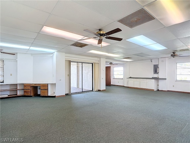 basement with a paneled ceiling and carpet floors