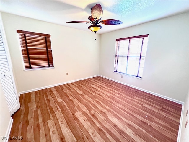 spare room featuring ceiling fan and light wood-type flooring