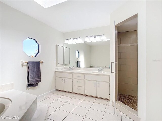 24313 Pirate Harbor Blvd, Punta Gorda, FL 33955 - bathroom featuring double vanity, tile patterned flooring, a stall shower, and a sink