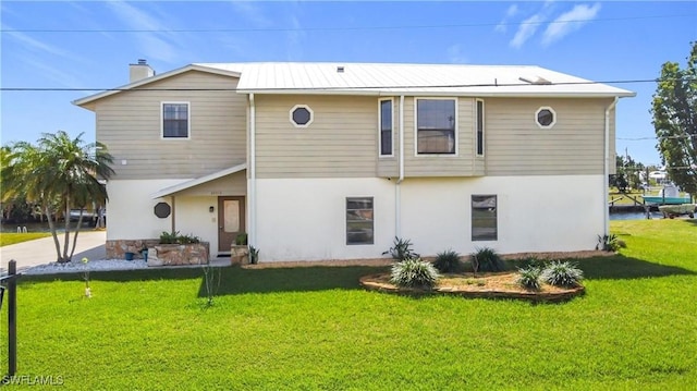 24313 Pirate Harbor Blvd, Punta Gorda, FL 33955 - view of front of house featuring stucco siding, a chimney, and a front yard