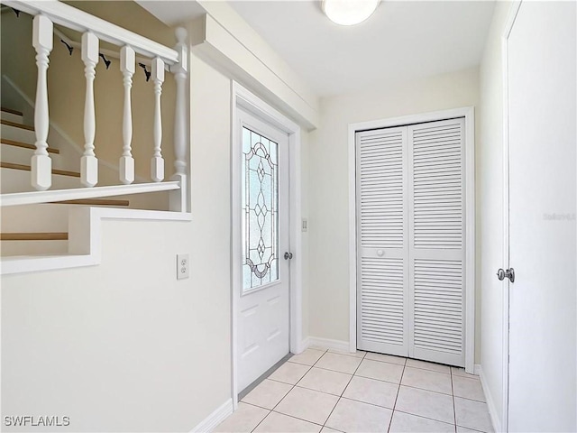 24313 Pirate Harbor Blvd, Punta Gorda, FL 33955 - entryway featuring baseboards, stairs, and light tile patterned floors