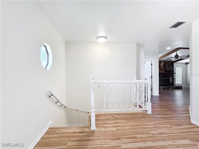 24313 Pirate Harbor Blvd, Punta Gorda, FL 33955 - corridor with wood finished floors, visible vents, a wealth of natural light, and an upstairs landing