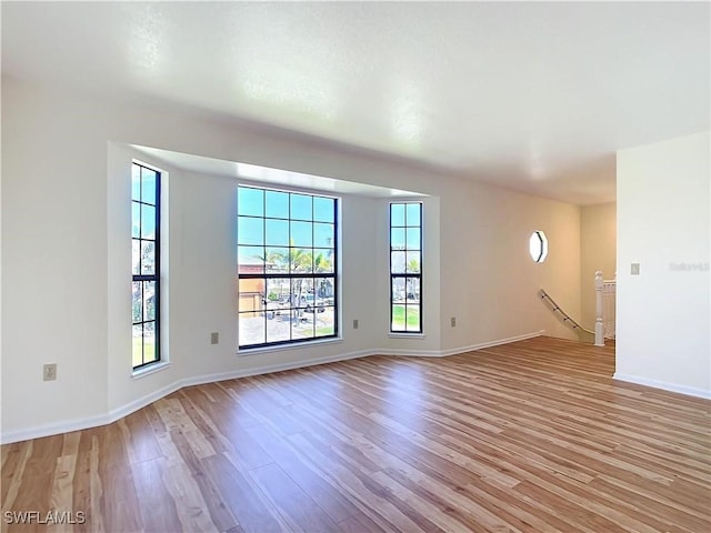 24313 Pirate Harbor Blvd, Punta Gorda, FL 33955 - unfurnished living room featuring light wood-style floors and baseboards