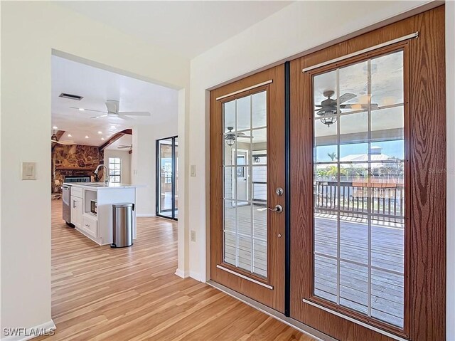 24313 Pirate Harbor Blvd, Punta Gorda, FL 33955 - doorway to outside with light wood-type flooring, ceiling fan, and french doors