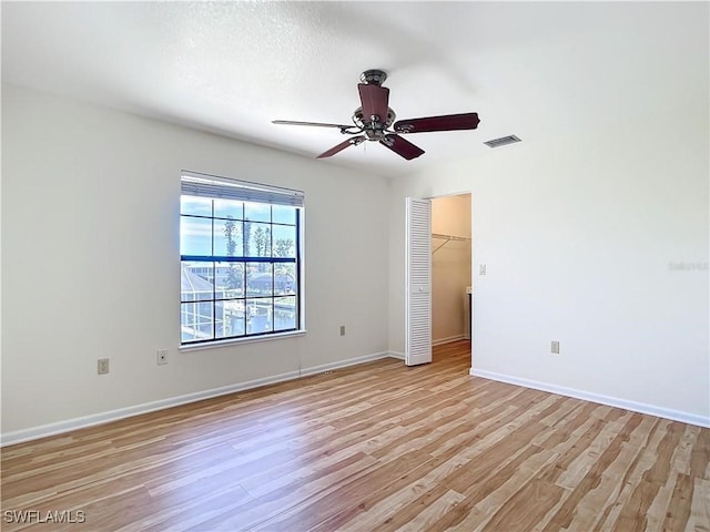 24313 Pirate Harbor Blvd, Punta Gorda, FL 33955 - empty room with light wood-type flooring, baseboards, a ceiling fan, and visible vents
