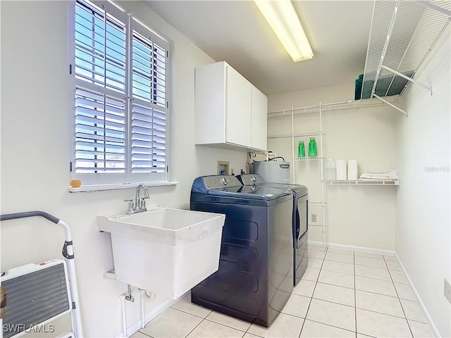 24313 Pirate Harbor Blvd, Punta Gorda, FL 33955 - clothes washing area with a healthy amount of sunlight, light tile patterned floors, a sink, independent washer and dryer, and cabinet space
