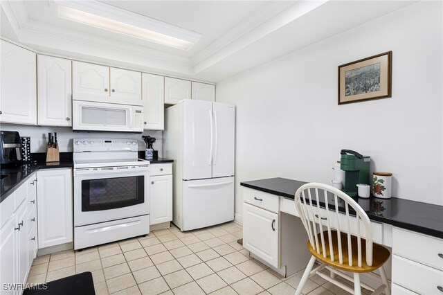 kitchen with white cabinets, crown molding, light tile patterned floors, a tray ceiling, and white appliances