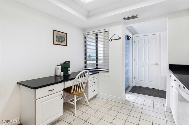 tiled office featuring a tray ceiling and crown molding