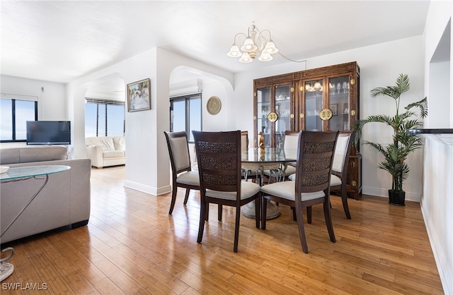 dining room with wood-type flooring and a chandelier